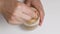 Top view of person hand stirring latte coffee with spoon