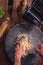 Top view of a person mixing flour and eggs together with bare hands