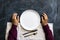 top view of person\'s hands on the table with empty plate design mock up designs