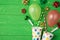 Top view photo of birthday composition blast from paper dotted cups of tinsel sparkles red green golden ribbon stars straws pipes