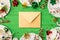 Top view photo of birthday party composition closed craft paper envelope in the middle ribbon stars candles pipes straws hat