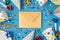 Top view photo of birthday party composition closed craft paper envelope in the middle spiral tubes ribbon stars candles pipes