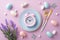 Top view photo of blue plate with pink alarm clock knife fork colorful easter eggs bunny butterflies bouquet of lavender