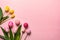 Top view photo of bouquets of pussy willow pink yellow and pink tulips on isolated pastel blue background with copyspace