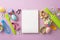 Top view photo of copybook kitchen utensils whisk rolling pin brushes colorful easter eggs in paper baking molds and sprinkles