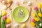 Top view photo of green plate with inscription happy easter knife fork colorful eggs ceramic bunnies