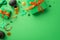 Top view photo of green present boxes with orange ribbon bows pots with gold coins horseshoe tie bow clovers and confetti