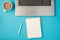 Top view photo of grey laptop two organizers pen and cup of drink on isolated pastel blue background with blank space