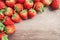 Top view photo, a heap of fresh berry fruit, red strawberry on wooden floor with coppy space