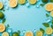 Top view photo of mint leaves whole and sliced limes halves of lemon ice cubes and water drops on isolated pastel blue background