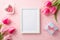 Top view photo of photo frame pink tulips heart shaped saucer with sprinkles and small blue giftbox on pastel pink background