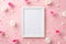 Top view photo of photo frame white and pink rose buds small hearts and sprinkles on pastel pink background with copyspace