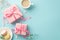 Top view photo of pink gift boxes with bows saucer with macarons mug of coffee small hearts and gypsophila flowers