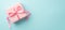 Top view photo of pink giftbox with ribbon bow on isolated pastel blue background with copyspace