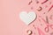 Top view photo of pink stationery adhesive tapes pins binder clips scissors pencil felt pen ruler and white paper heart on