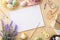 Top view photo of sketchbook brushes colorful easter eggs in bowl wooden decor ribbon chicken nest and lavender flowers