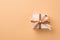 Top view photo of st valentine`s day decorations white giftbox with glowing brown and light beige ribbon bow on isolated beige