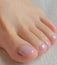 Top view photo of woman feet with pink toenails