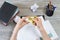 Top view photo of woman`s hands playing with fidget spinner while having break at work. Popular and hot toy. Top high angle close