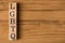 Top view photo of wooden cubes labeled LGBTQ on  wooden background with copyspace