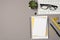 Top view photo of workstation glasses on keyboard flowerpot stationery binder clips pencil pens and stack of organizers on