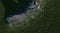 Top view photograph of a forest filled with green trees scattered throughout the area around noutain, demonstrating its richness