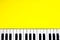 Top view piano keys over yellow background. Pianist musician, pianist concept. Music Keyboard. Copy space