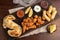 Top view of a picada board with nuggets and tequenos with lemon slices and white and spicy sauces
