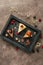 top view of pieces of delicious cakes with chocolate and berries on wooden tray