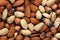 Top view of a pile of almonds, hazelnuts and peanuts. Background illustration of various natural fresh nuts, AI Generated
