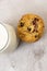 Top view of a pile of chocolate chip cookie beside a glass of milk on a table