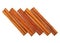 Top view of pile of cinnamon sticks on white background