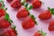 Top view of pile of strawberries on white surface with blank copy space