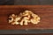 Top view of a pile of walnuts on a wooden surface with a blurry background