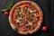 Top view of pizza with pelati sauce, cabanossi, salami, bacon, ham