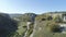 Top view of plantation in mountain valley. Shot. Panorama from stone ridge of rock cliffs to green valley in sunny