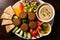 top view of a plate with falafel, hummus, and salad