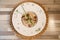 Top view of a plate of mushroom risotto in a wooden table