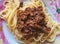 Top view on a plate with spaghetti topped with fried force meat