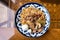 Top view of a plate with Uzbek oriental pilaf with pieces of lamb, horse meat, quail rice and chicken egg. Central Asian