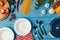 top view of plates and uncooked food on blue table