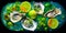 top view of platter of fresh oysters with lemon on a bed of ice on black background