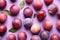 Top view of plum fruits on violet background