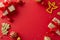 Top view of polished gift boxes, baubles, angel toy, golden confetti on cheerful red background