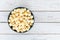 Top view popcorn in blue bowl on white wooden table