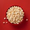 Top View of Popcorn Bowl on Red Background. Generative AI