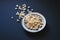 Top view of popcorn in a metallic plate on a matte black surface