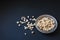 Top view of popcorn in a metallic plate on a matte black surface