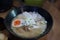 Top view, pork ramen, Japanese-style food with eggs and vegetables, herbs in delicious cups.