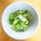 Top view of portion of green lettuce in bowl